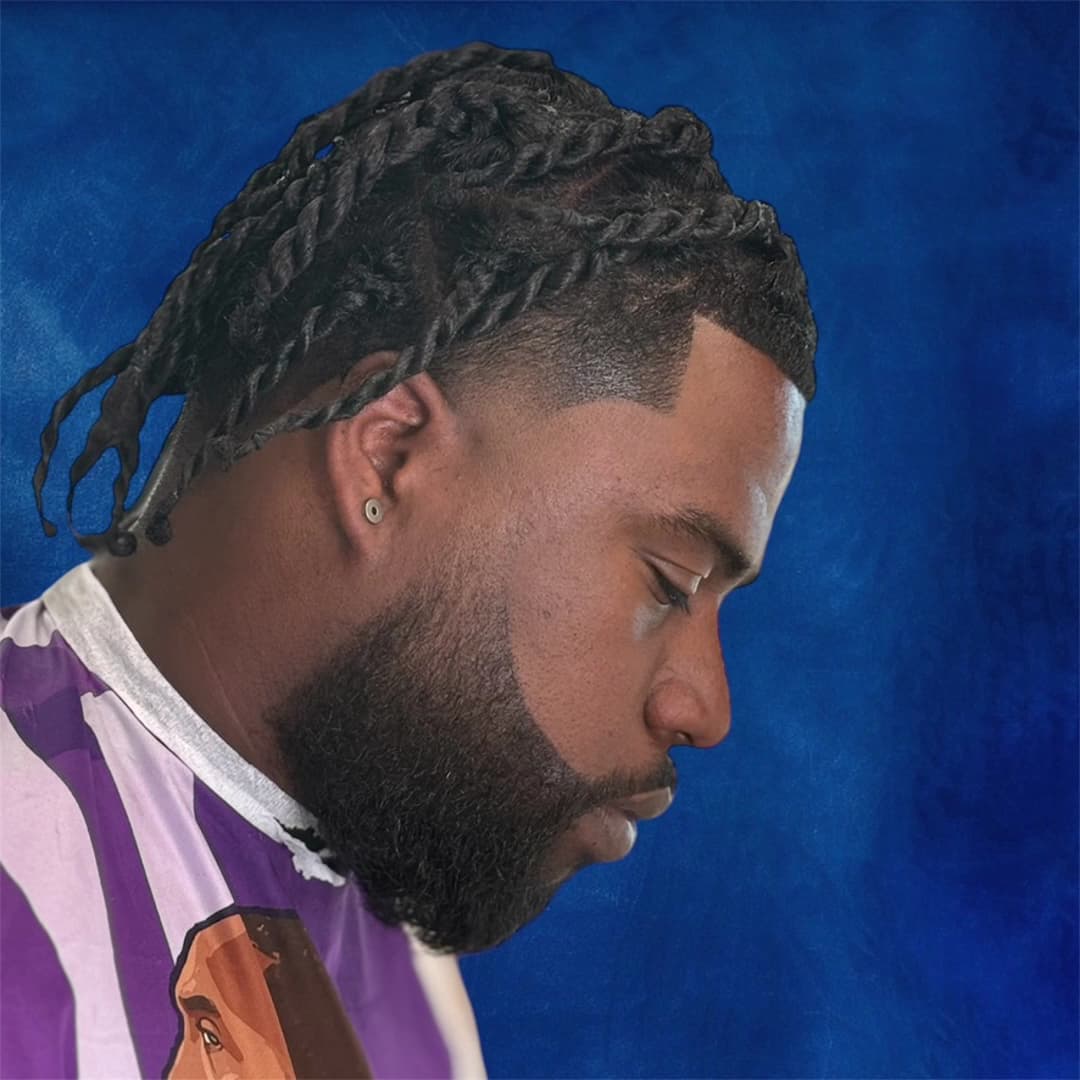 Two-strand twists with a razor-sharp line up and a shaped full beard